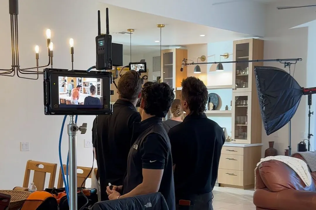 Crew filming kitchen set